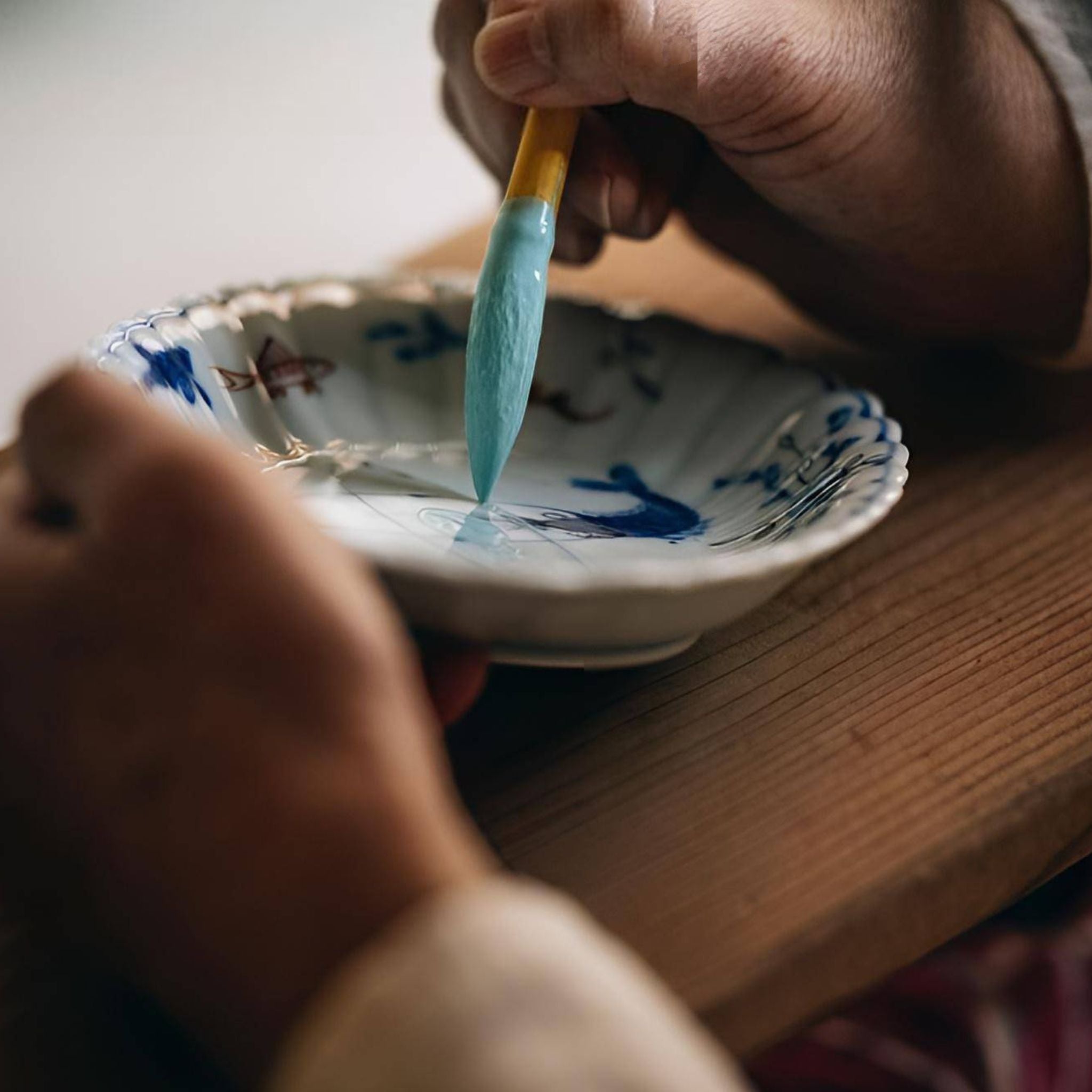 Artisan from Keizan Kiln painting the plate