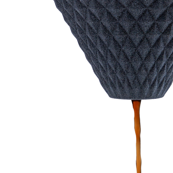Close up of dripping coffee with Hasami ware ceramic coffee filter in black