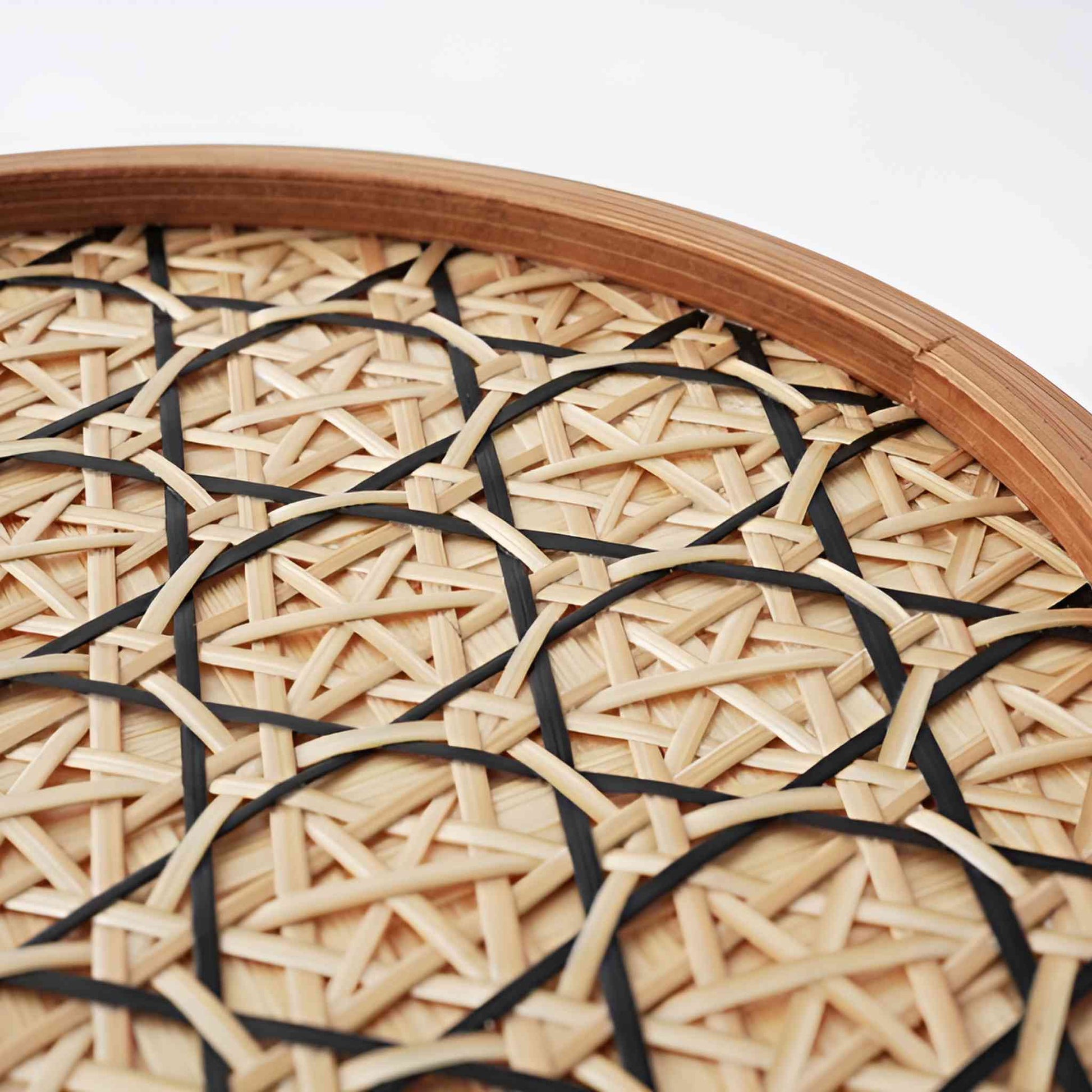 Close-up of the intricately woven hexagonal design on the bamboo basket lid, emphasizing the artisan's attention to detail.