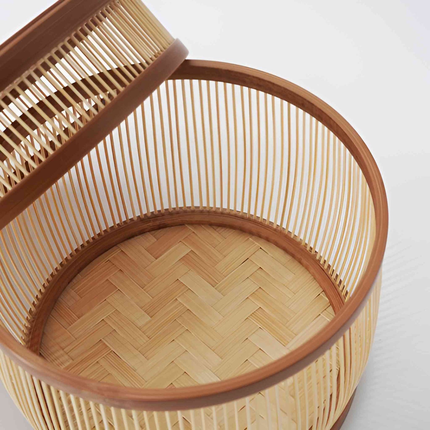 Open bamboo basket showcasing the delicate vertical weave of the sides and a herringbone-style pattern on the base, crafted from natural bamboo.