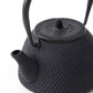 Close-up of the black Nanbu cast iron teapot’s spout and textured body, showcasing the intricate dotted design.