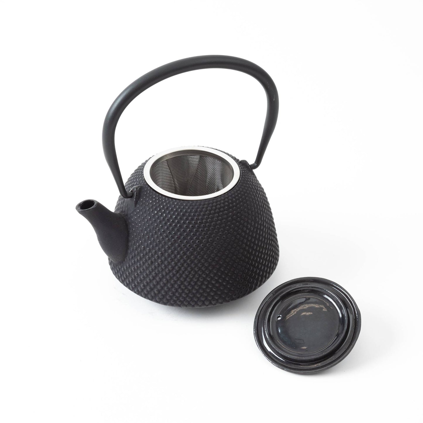 Black Nanbu cast iron teapot with the lid removed, revealing the stainless steel tea infuser inside.