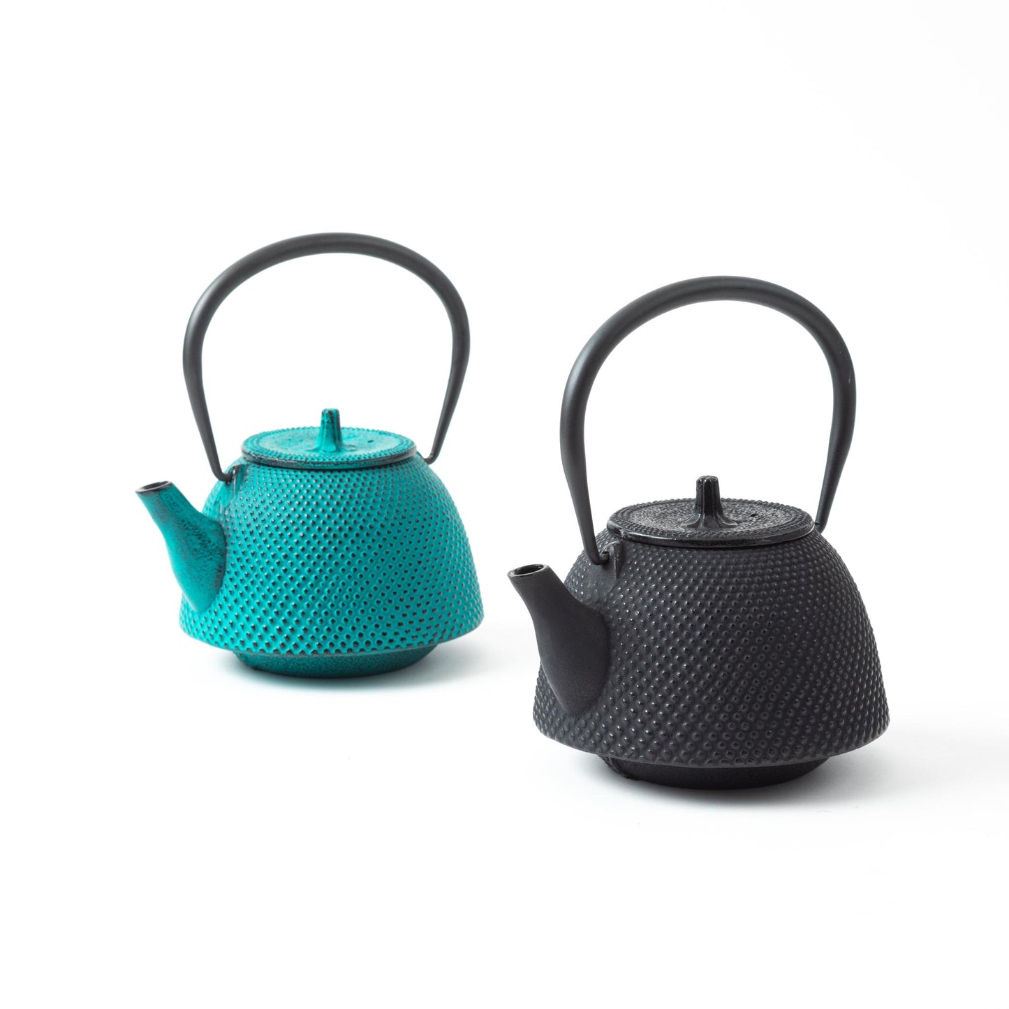 Classic Arare Sky Blue and Black Nanbu Cast Iron Teapots side by side, highlighting the contrasting colors and traditional Japanese design.