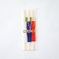 A packaged set of three wooden chopsticks in colorful dotted sleeves—white, red, and blue—secured with decorative Mizuhiki cords, neatly encased in a transparent plastic sleeve for presentation.