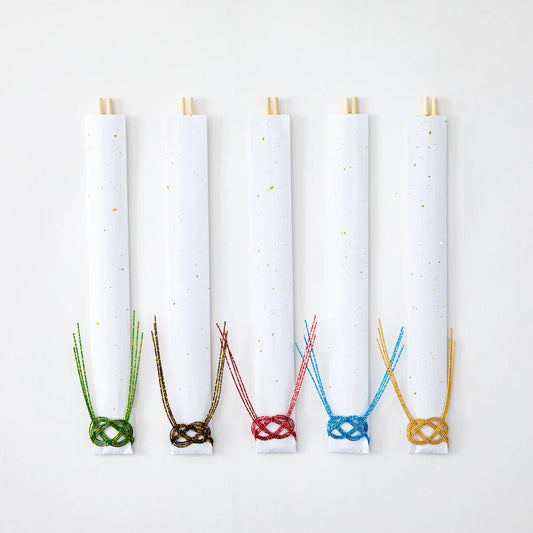 Set of 5 guest chopsticks individually wrapped in white paper sleeves with gold accents, each adorned with colorful mizuhiki knots in green, brown, red, blue, and gold, laid out flat for display.