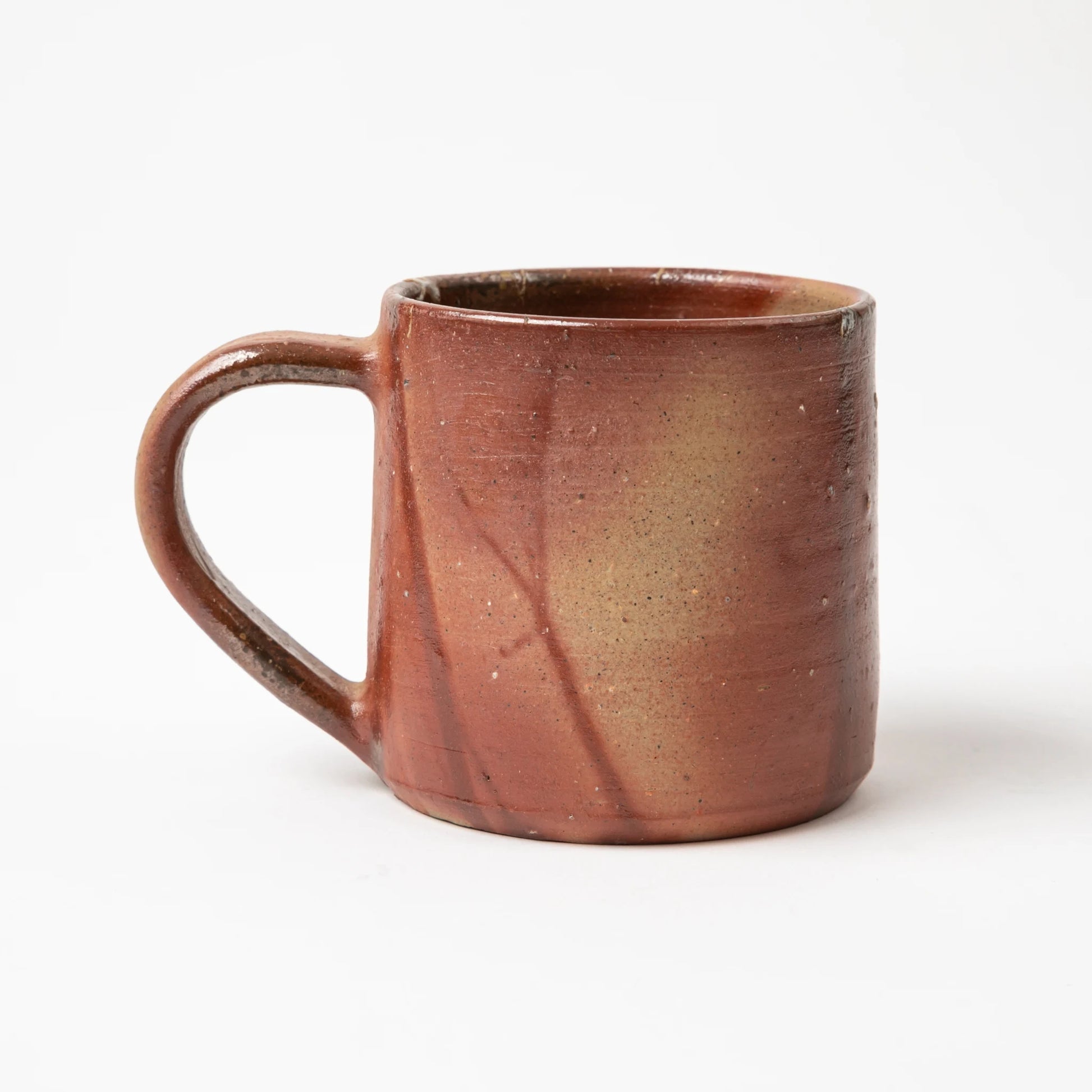 Another side angle of the Hozan Kiln Hidasuki Mug, emphasizing its smooth handle and unique color variations.