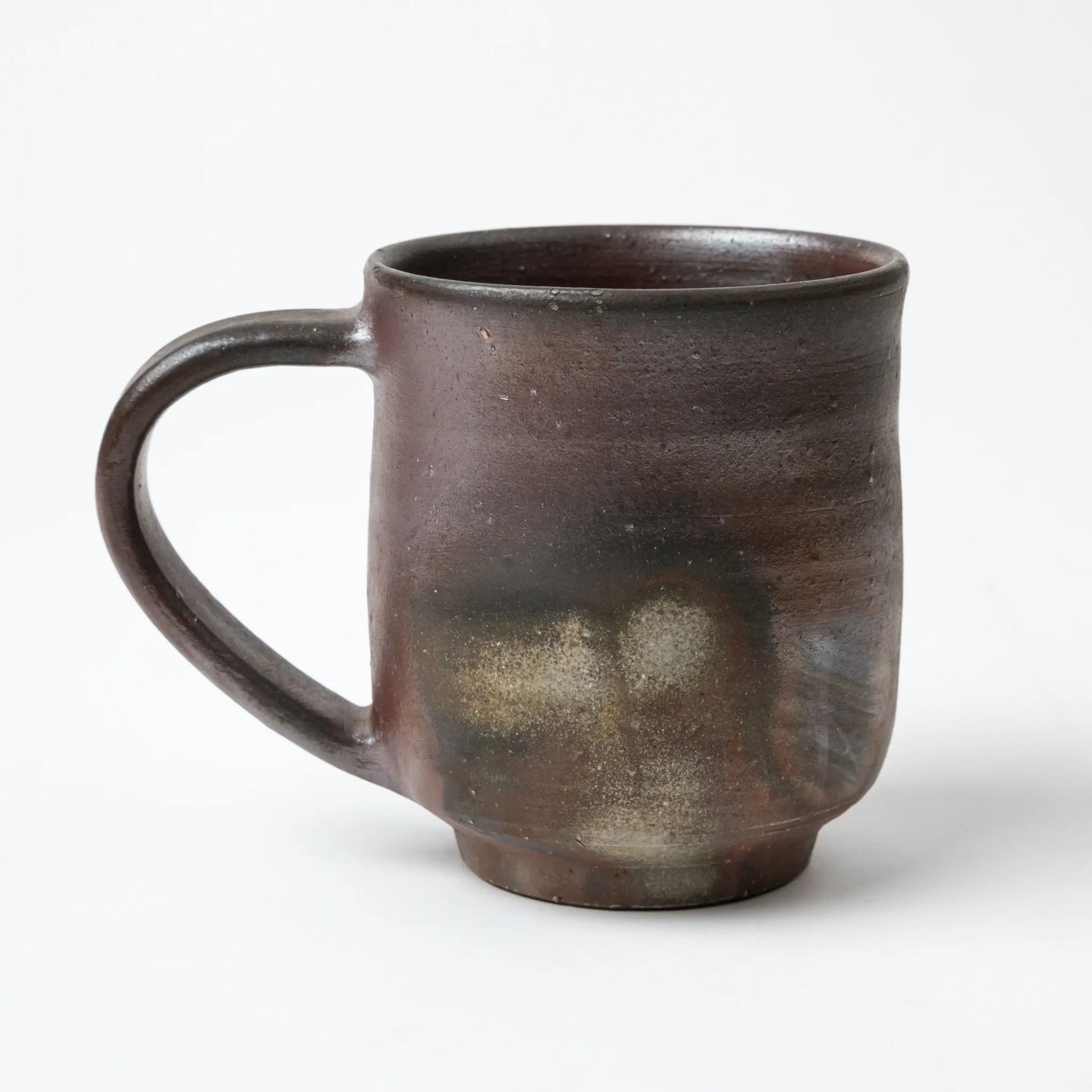 Another side view of the Hozan Kiln Sangiri Large Mug, highlighting the subtle transitions between brown, black, and smoky grey.