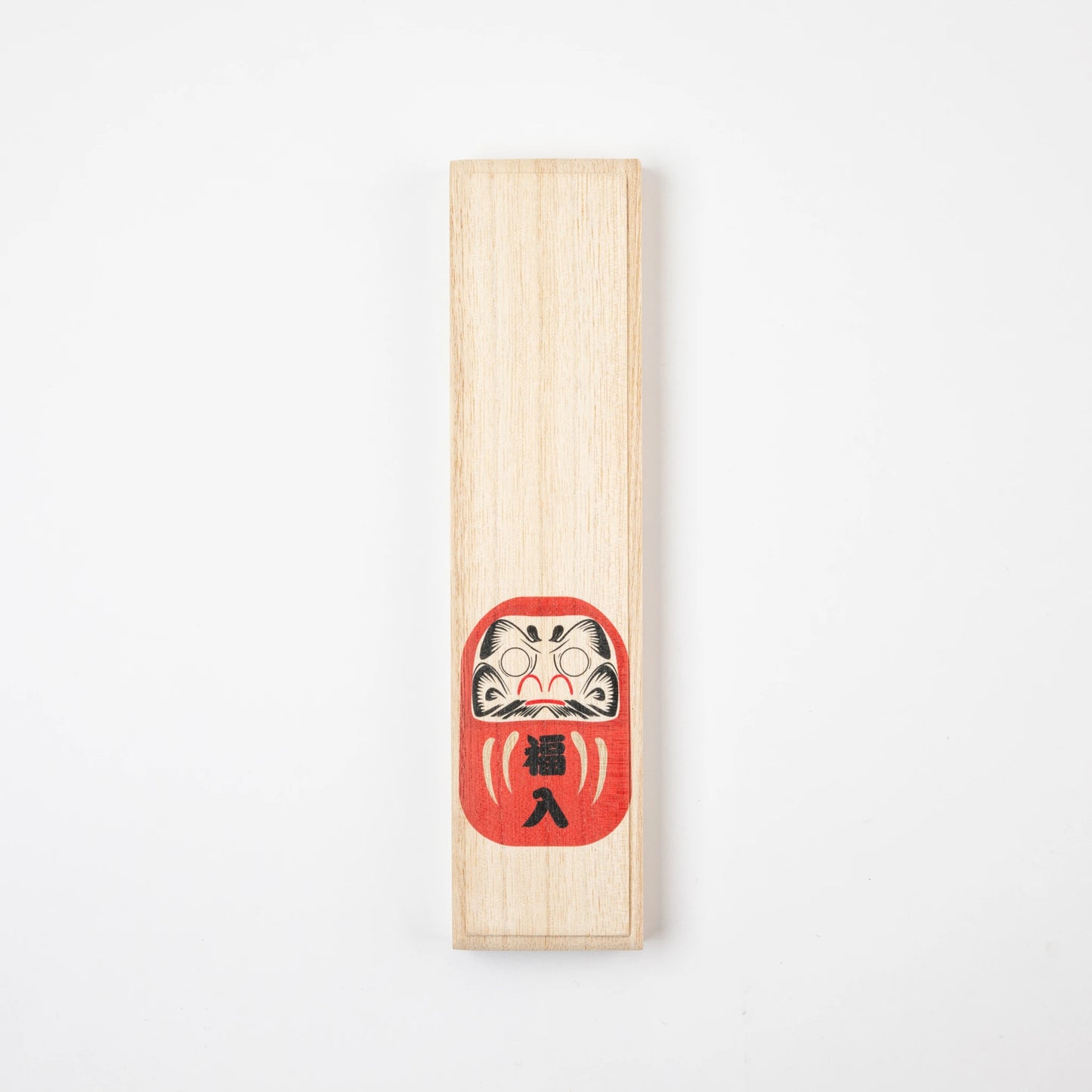 Closed wooden box with a red Daruma illustration, symbolizing good fortune and resilience.