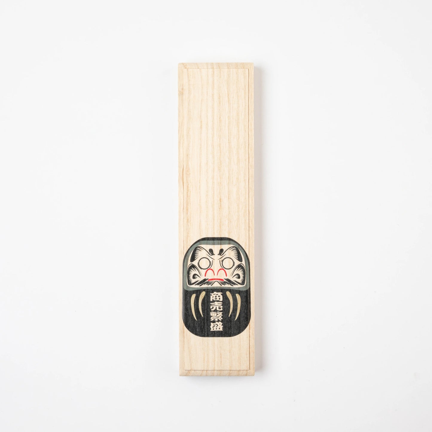 Closed paulownia gift box with a black Daruma illustration for Hyozaemon lacquer chopsticks.