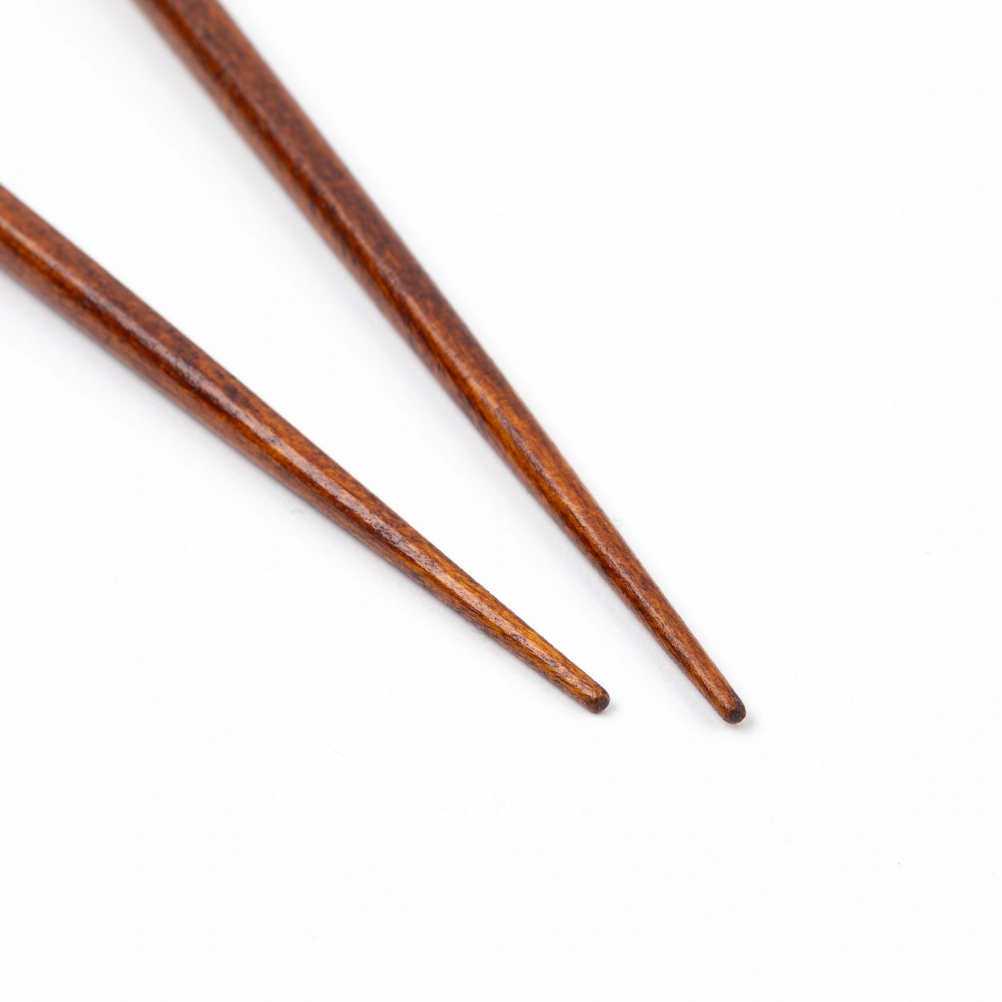 Close-up of finely tapered tips of Hyozaemon's Gold Sprinkle Lacquer Chopsticks for precision use.