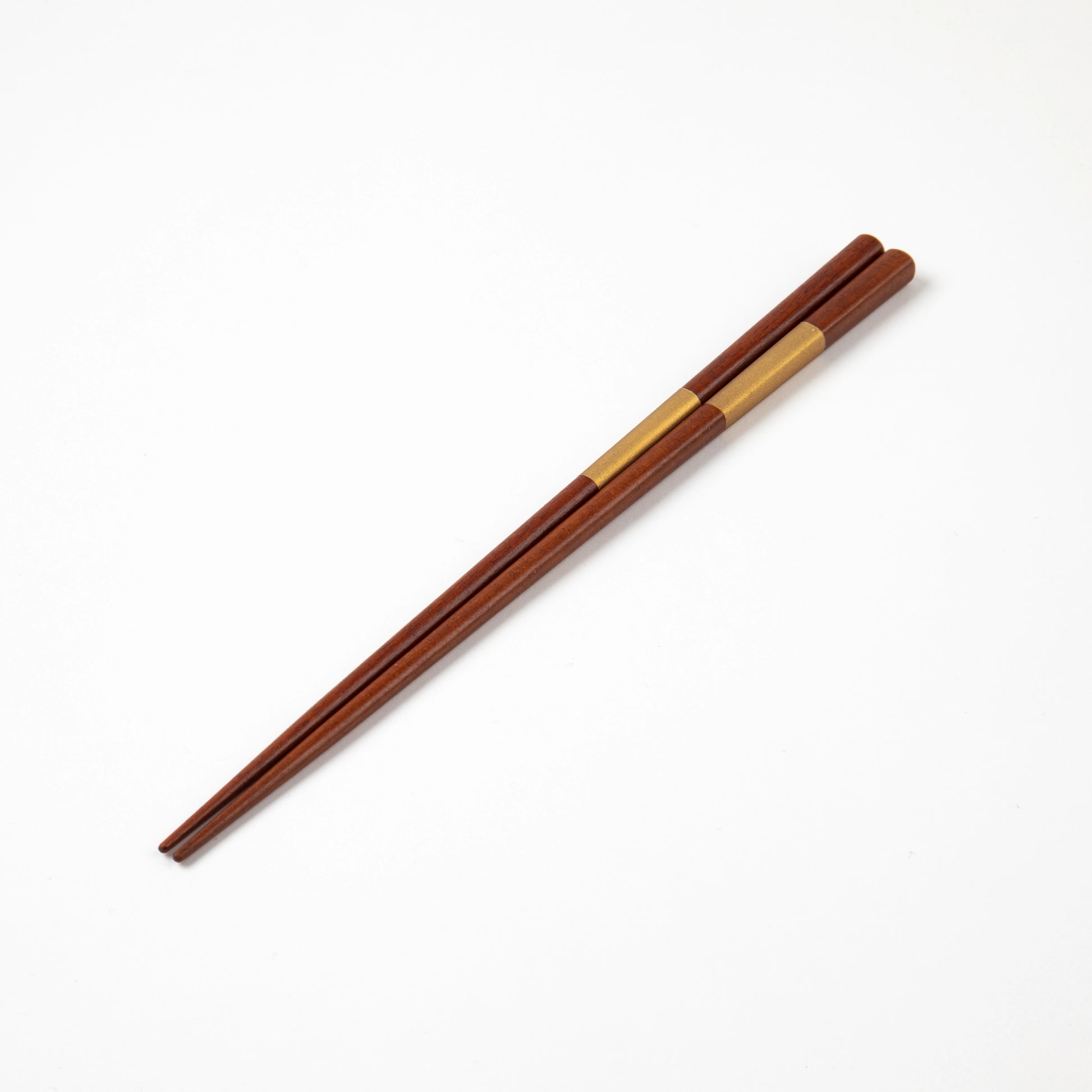 Elegant gold Ichimatsu lacquer chopsticks with a sleek and minimalist design against a white background.