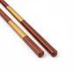 Close-up of the golden Ichimatsu pattern on the lacquered chopsticks showcasing fine craftsmanship.