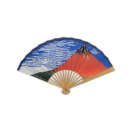 A traditional Japanese fan with the iconic Red Fuji design from Hokusai's "Thirty-Six Views of Mount Fuji." Vibrant red mountain under a bright blue sky with white clouds.