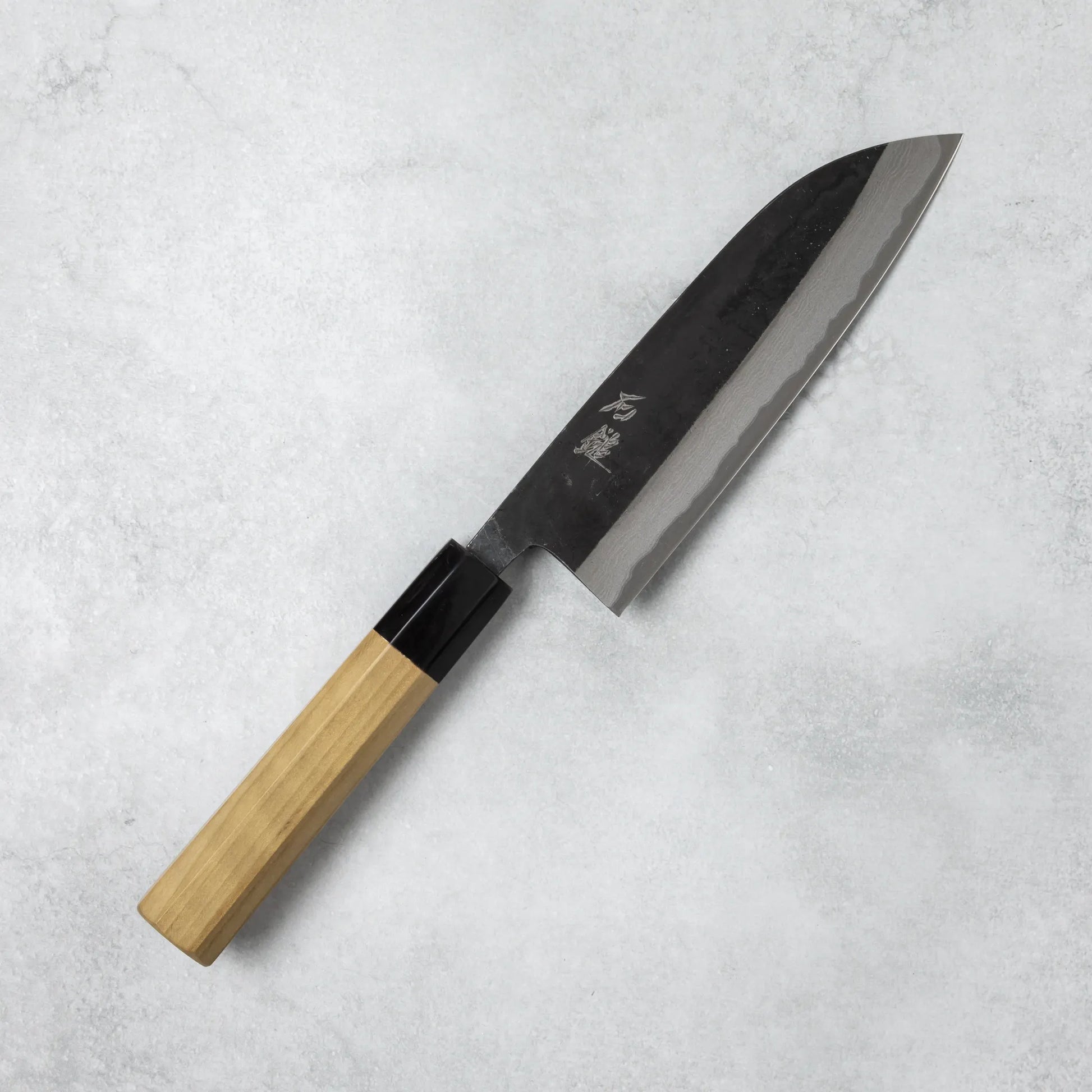 Full view of the Ishizuchi Blue Steel No.2 Santoku Damascus Knife with magnolia handle, showcasing a beautiful wave-like Damascus pattern and versatile Santoku blade shape.