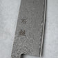 Focused shot of the kanji engraving on the Damascus blade of the Ishizuchi VG10 Chef Knife, emphasizing its craftsmanship and attention to detail.