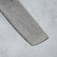 Zoomed-in view of the sharp edge and tip of the Ishizuchi VG10 Damascus Nakiri Knife, emphasizing the blade's precision and exquisite Damascus steel pattern.