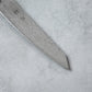 Zoomed-in view of the sharp edge and tip of the Ishizuchi VG10 Damascus Petty Knife, emphasizing the blade's precision and elegant Damascus pattern.