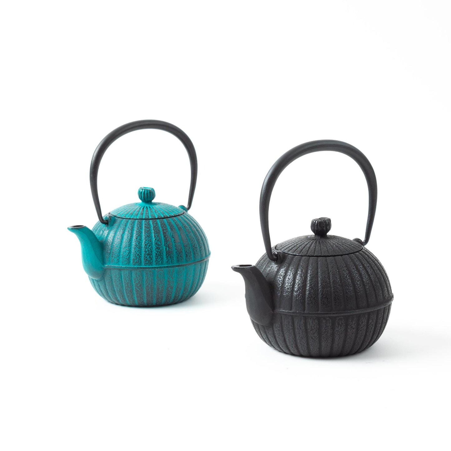 Japanese Aster Nanbu cast iron teapots in sky blue and black colors, both featuring ribbed patterns and traditional Japanese craftsmanship.