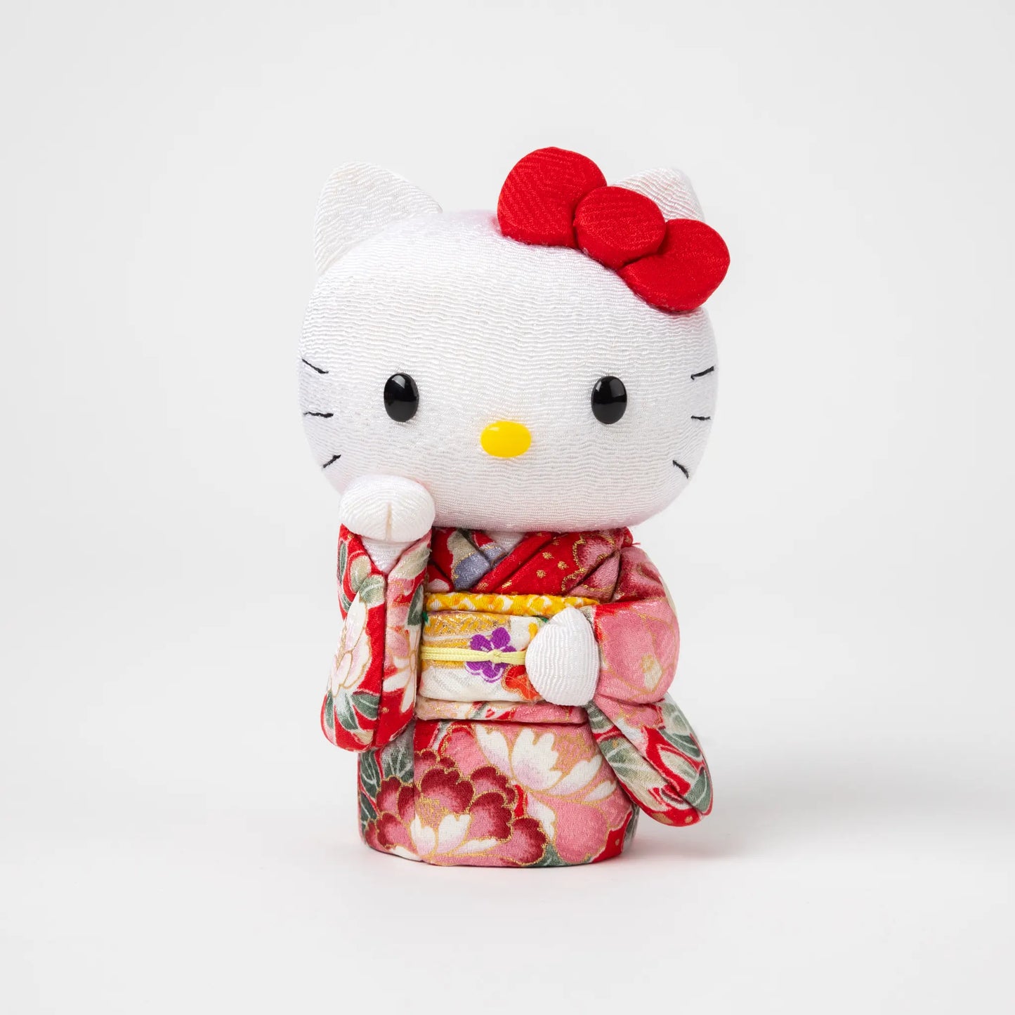 Front view of the Edo Kimekomi Kimono Maneki Hello Kitty Red, featuring Hello Kitty in a traditional Japanese kimono with a red floral pattern and a decorative bow on her head.