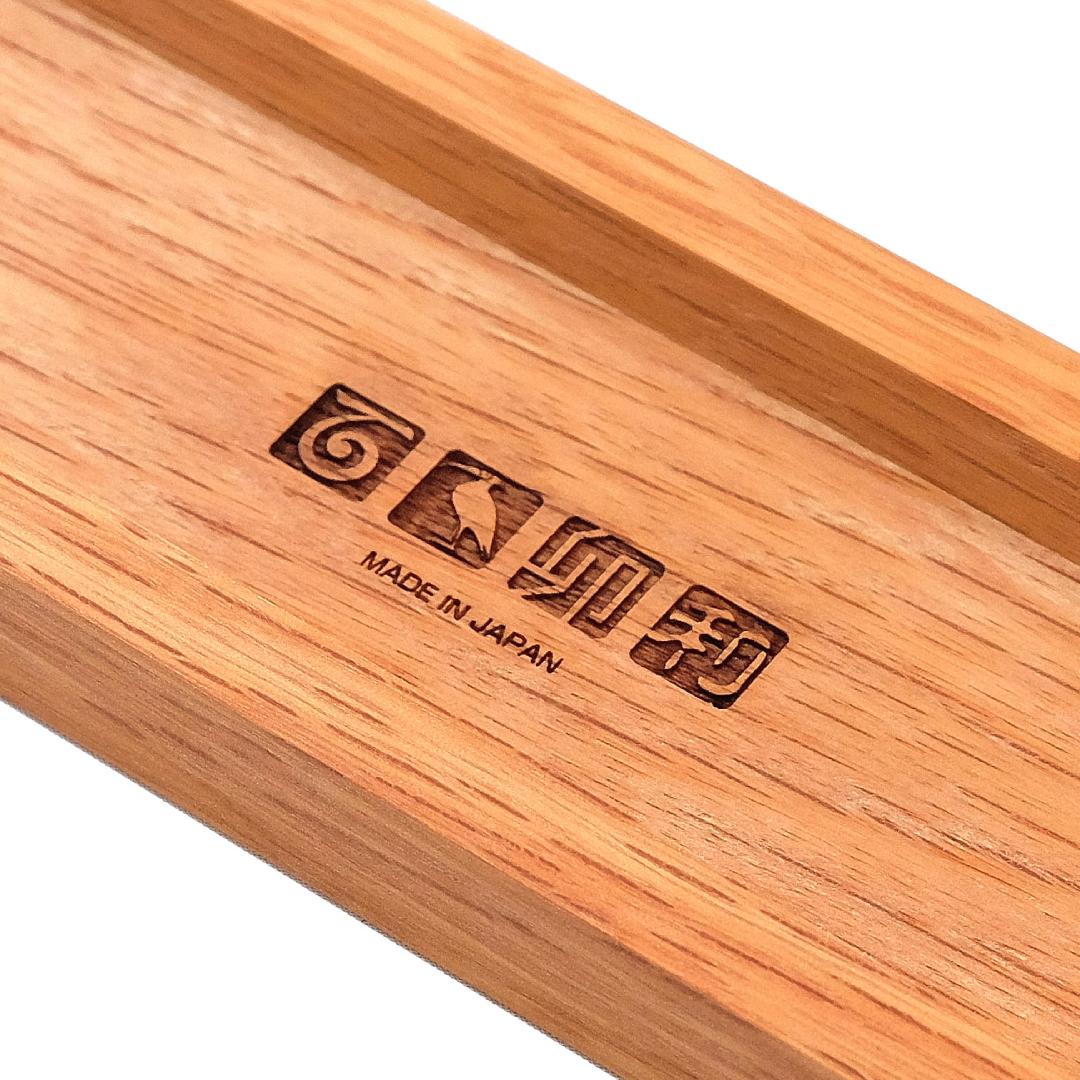 A detailed image showing the engraved Kakuri logo and 'Made in Japan' inscription on the wooden body of the shaver.