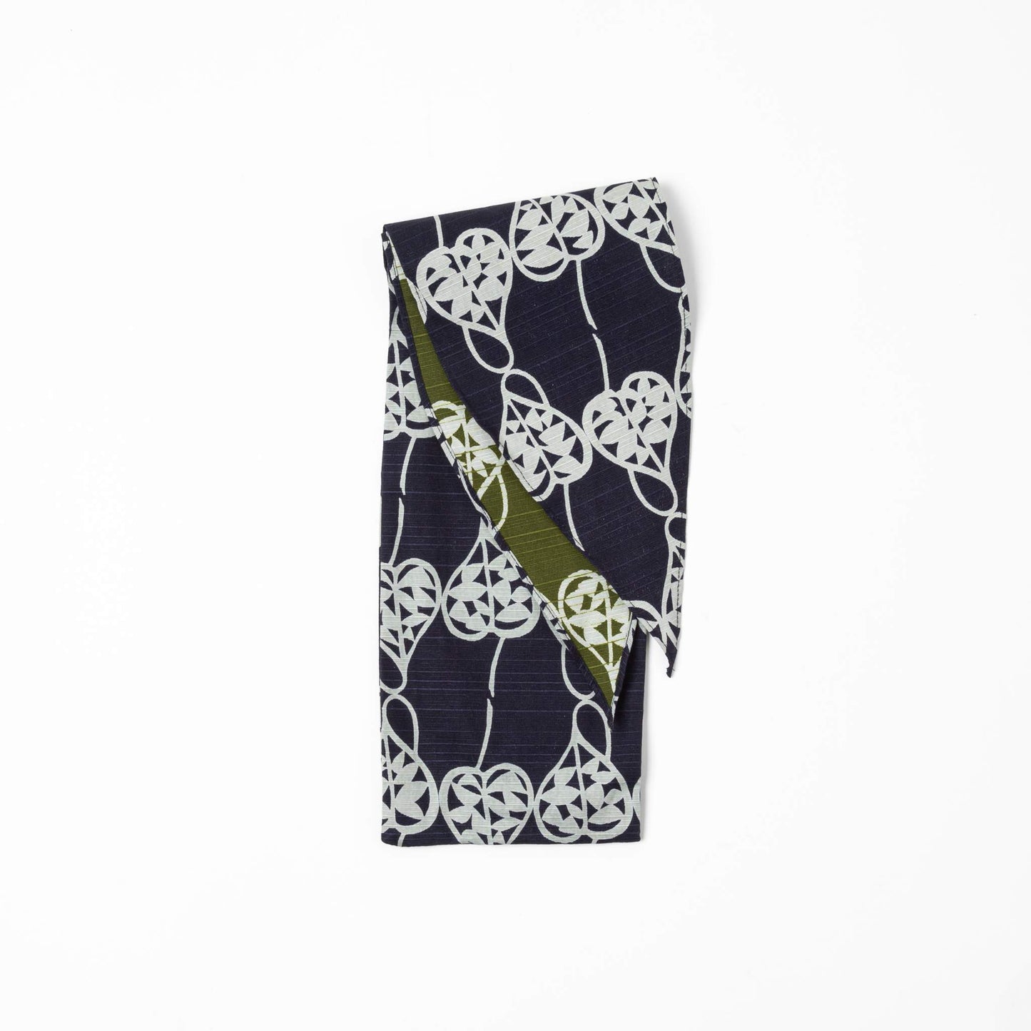 A folded Isa Moyō Folding Umbrella pouch displaying the Rosary Vine motif in deep navy with an inner lining of contrasting green.