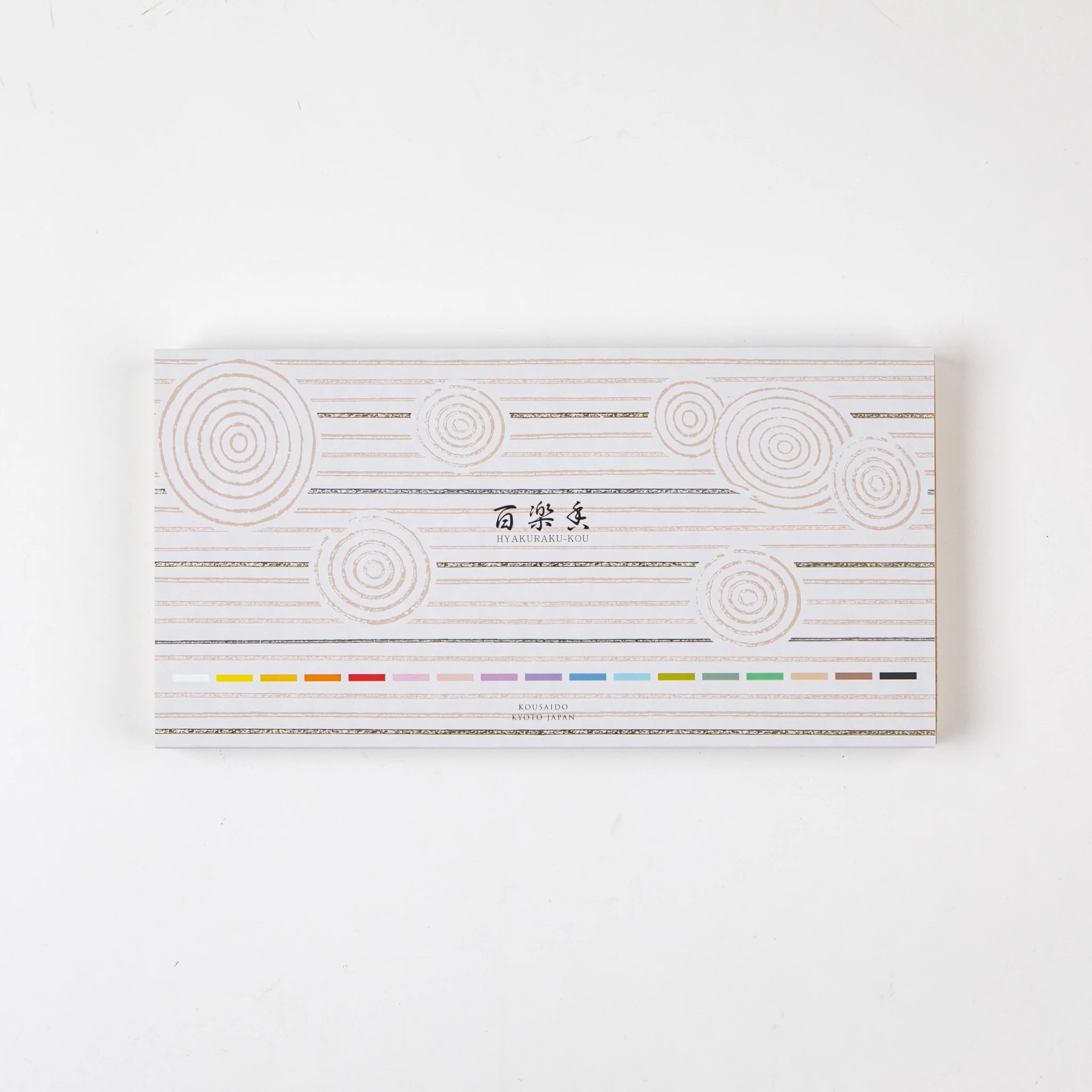 Closed box of Kosaido Hyakuraku-kou incense, decorated with circular line motifs and scent color indicators.