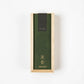 A top-down view of a rectangular wooden box with a green label reading "hitotoki Agarwood" in English and Japanese.