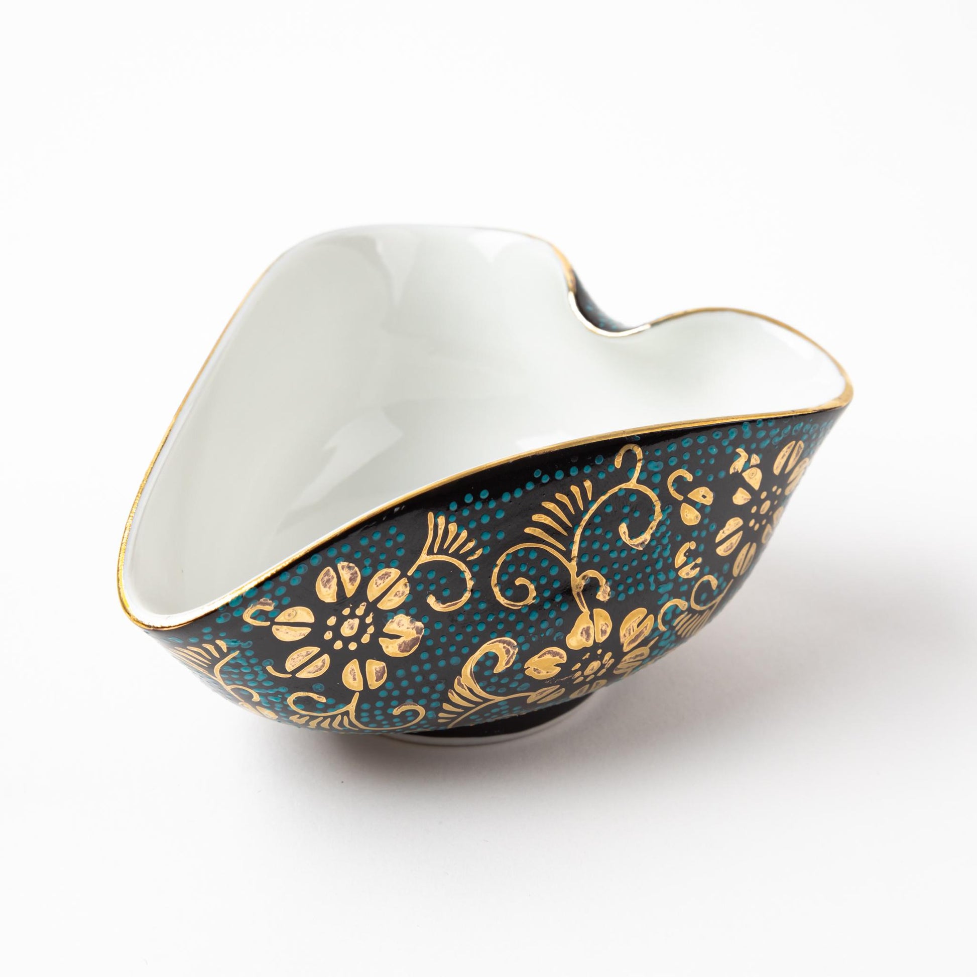 Pitcher for cooling hot water from the Kutani Aochibu Tessen tea set, featuring gold floral patterns on a dark blue and turquoise dotted design with a unique curved shape.