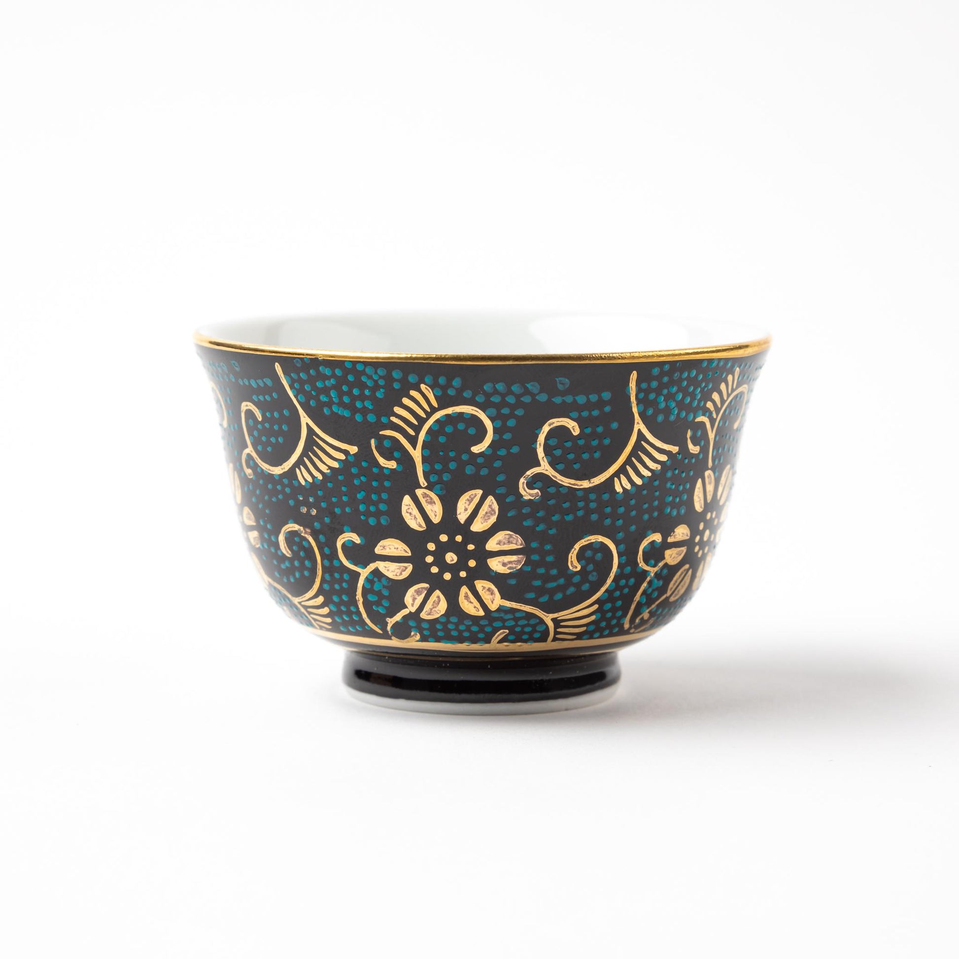 Close-up of a Kutani Aochibu Tessen tea cup, featuring elegant gold floral motifs and a turquoise dotted pattern over a dark blue background.