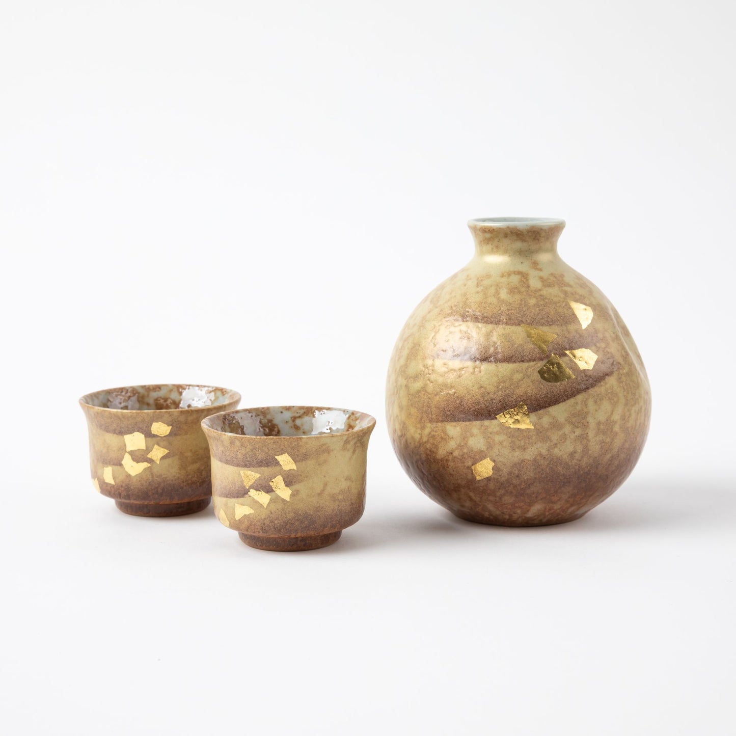 Handcrafted Kutani Gold Leaf Sake Set with earthy tones and gold leaf accents, featuring a bottle and two matching cups.