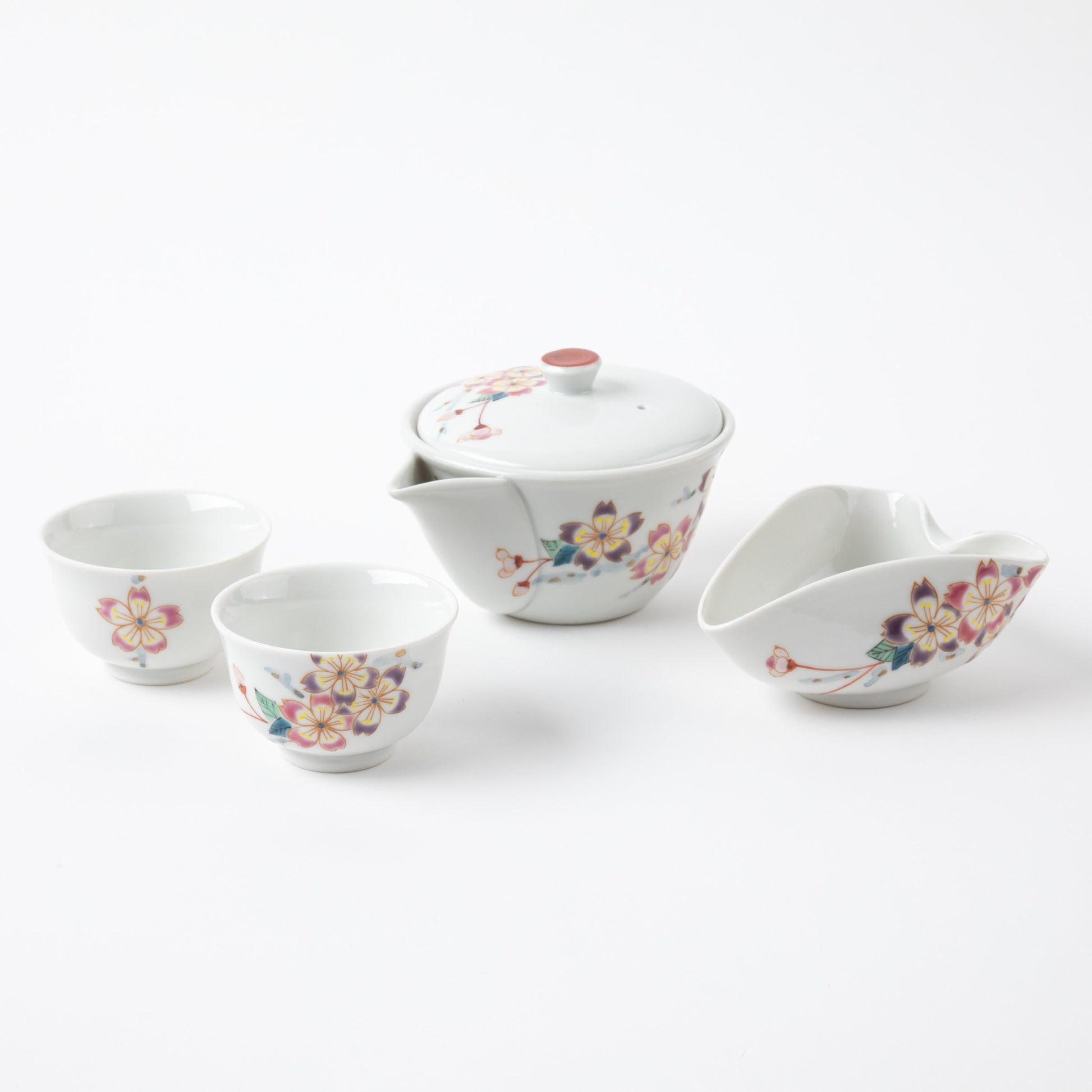 Complete Kutani Japanese Sakura tea set featuring a pitcher, two cups, and a water-cooling pitcher with hand-painted cherry blossom designs.