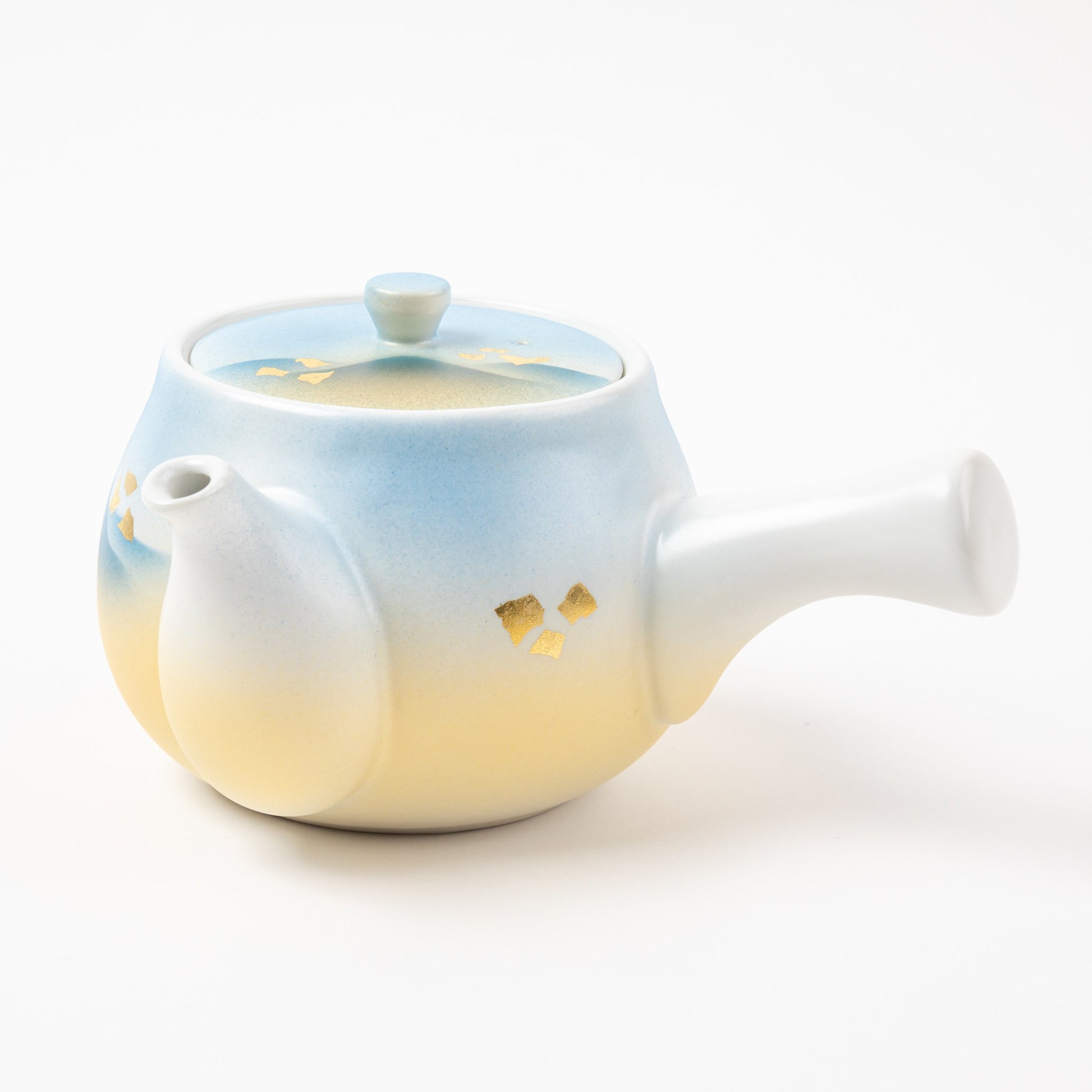 Side view of the Kutani Mountain Range teapot with gold leaf detailing and smooth porcelain handle