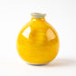 A back view of the yellow Kutani sake bottle, showing its smooth, glossy surface without any decorations, emphasizing the richness of the yellow glaze.