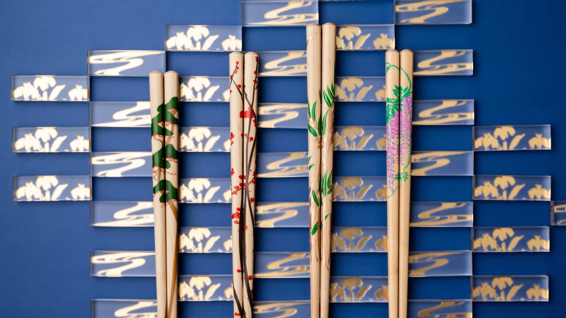 Close-up image of Matsukan Rimpa Chopsticks sets featuring japanese traditional motif. Chopsticks rests are in background.