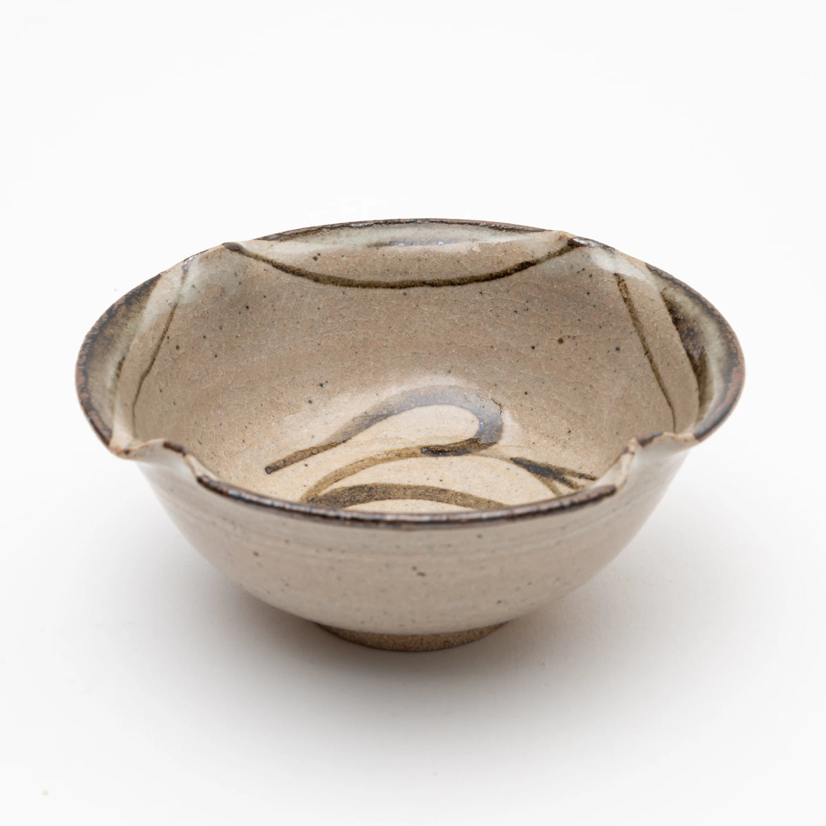 Three-quarter view of the Nakazato Tarouemon E-Karatsu susuki mukozuke serving dish, showing the rounded form with lobed rim and iron-oxide susuki brushwork visible inside the bowl against the pale stoneware ground.