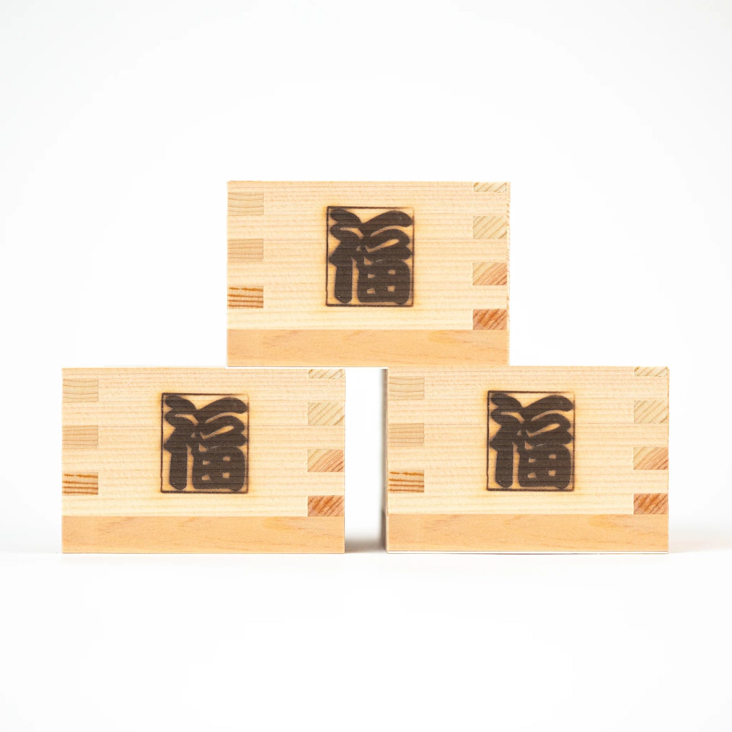 Three stacked masu cups featuring 'Fuku' (fortune) engraved on the front