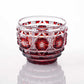 Crimson Satsuma Kiriko sake cup with intricate geometric and starburst patterns.