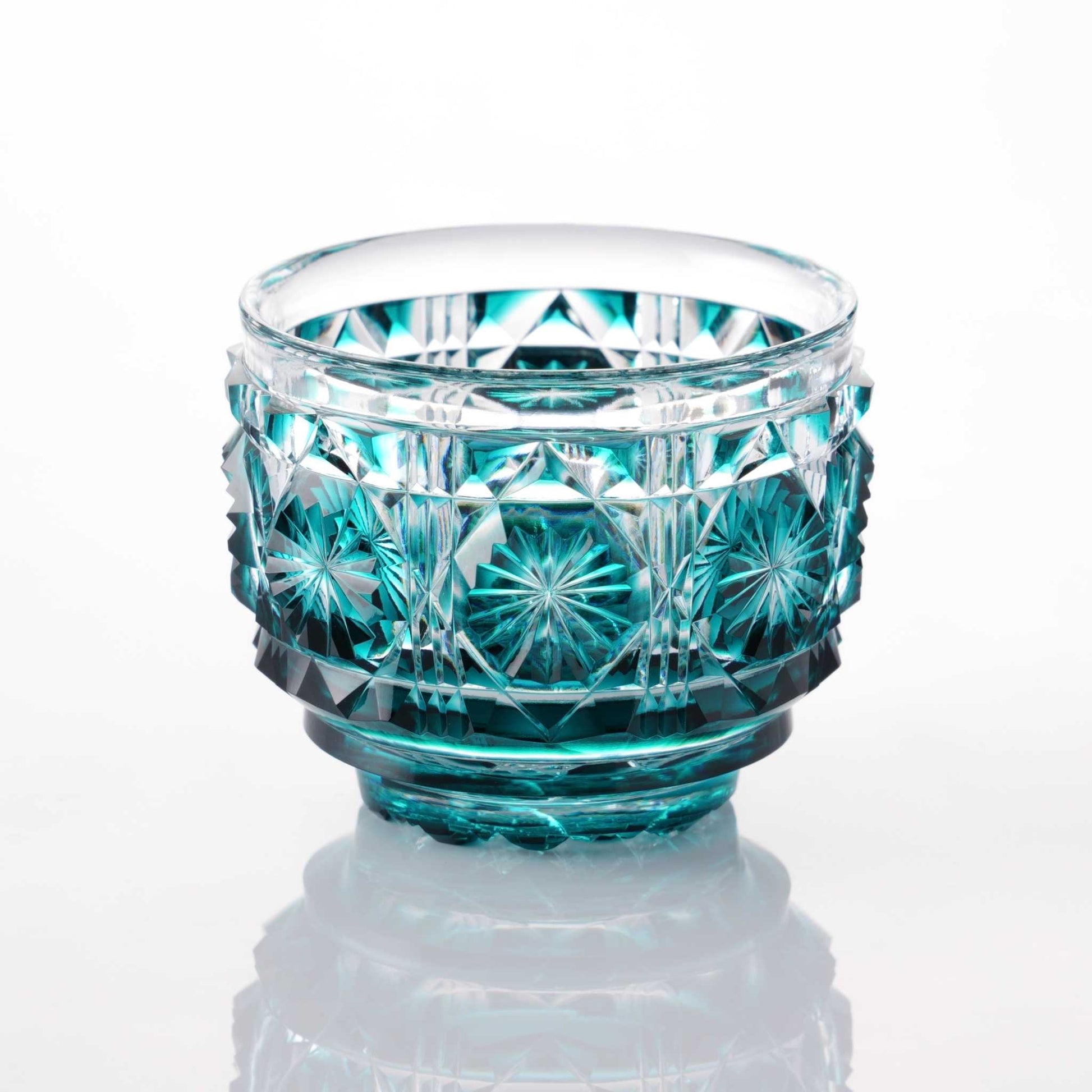 Green Satsuma Kiriko sake cup with traditional geometric and starburst patterns.