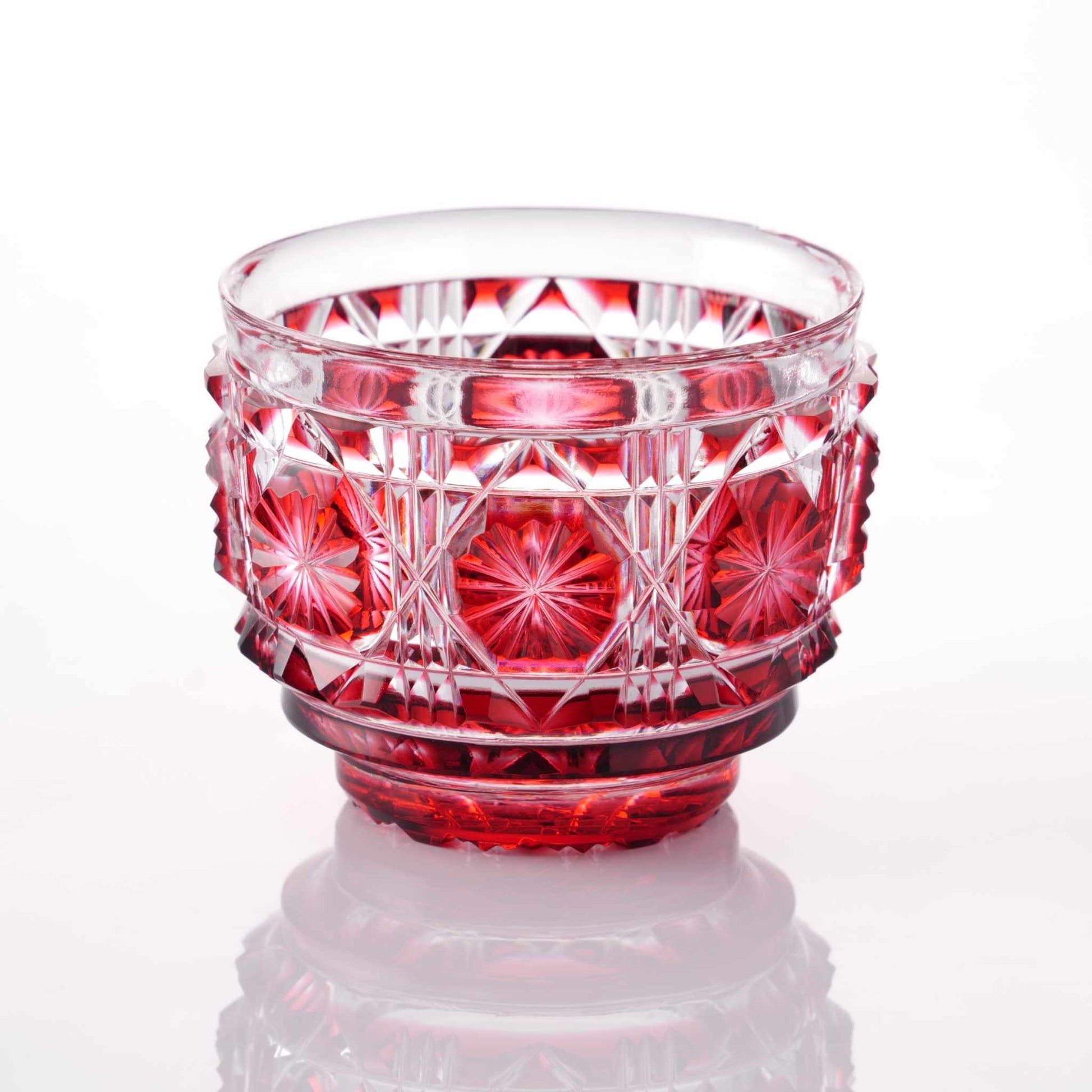 Satsuma Kiriko red sake cup with traditional geometric and starburst cuts.