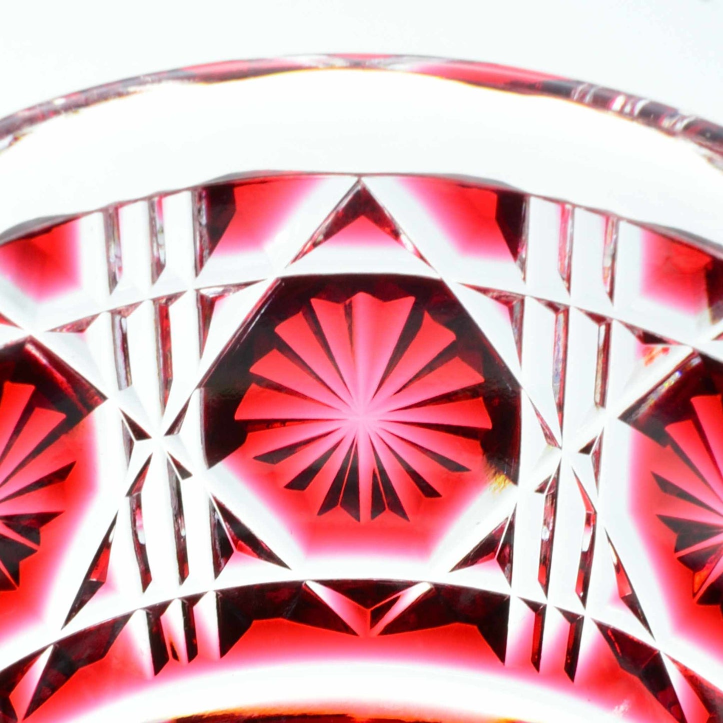 Detailed starburst pattern in red Satsuma Kiriko sake cup.