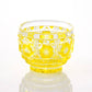 Satsuma Kiriko yellow sake cup with traditional starburst and geometric patterns.