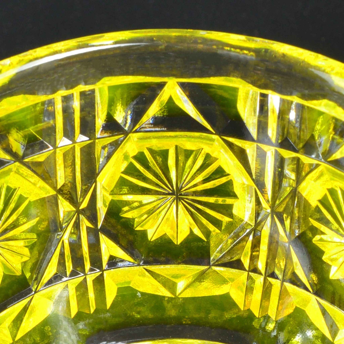 Intricate Satsuma Kiriko yellow sake cup with traditional starburst cut pattern.