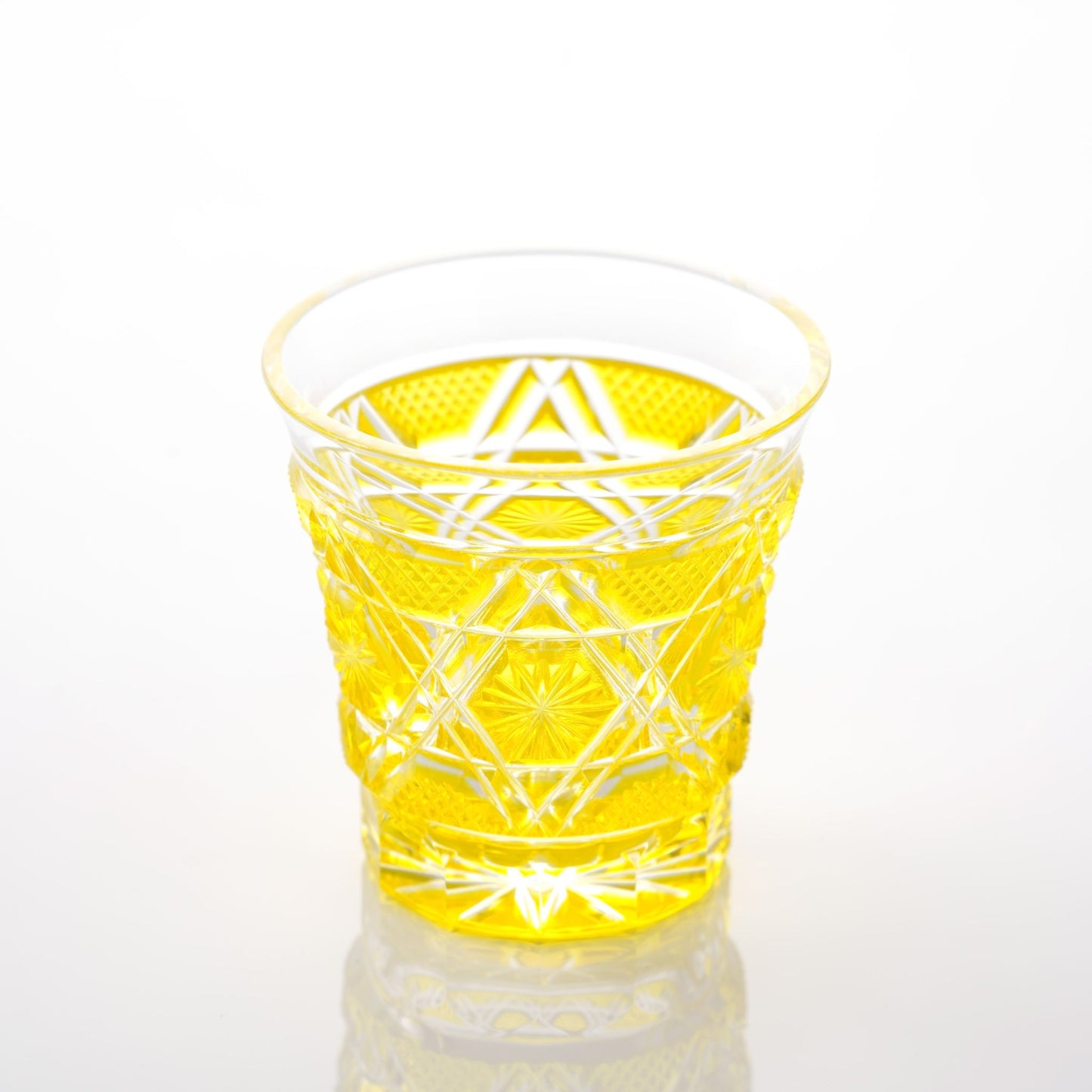 Angled top view of a Satsuma Kiriko two-tone yellow sake glass, showing delicate yellow glass details.