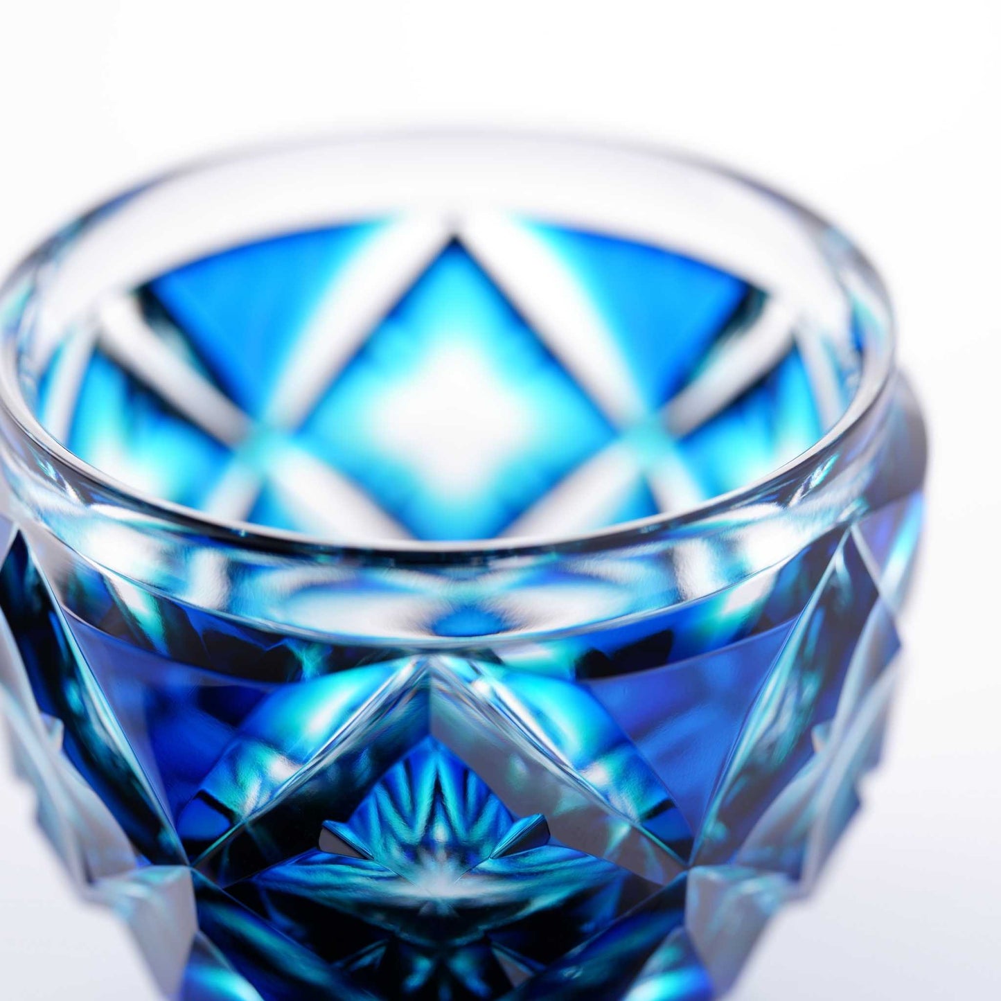 Close-up of a Satsuma Kiriko Lapis Green sake cup with intricate crystal-cut details.