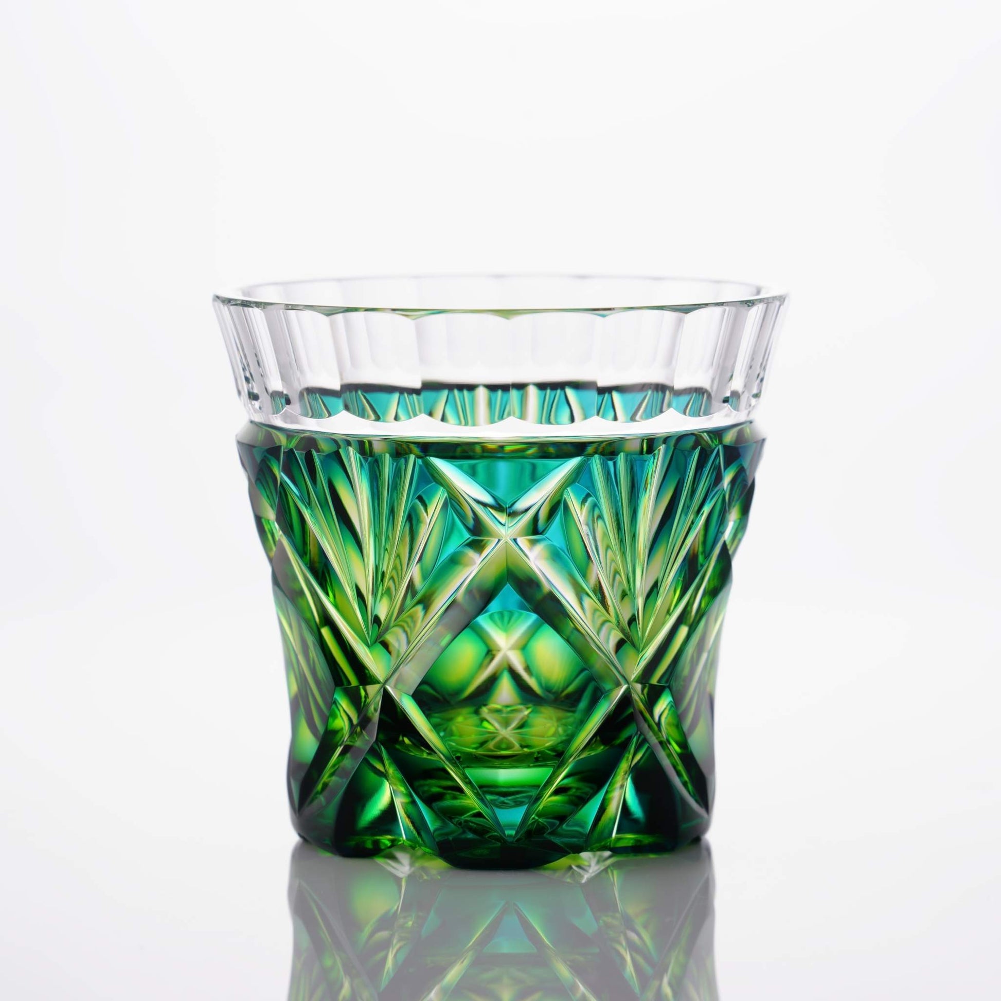 Standing view of Satsuma Kiriko two-tone sake cup in Cyan Yellow Green with clear upper rim and colored base.