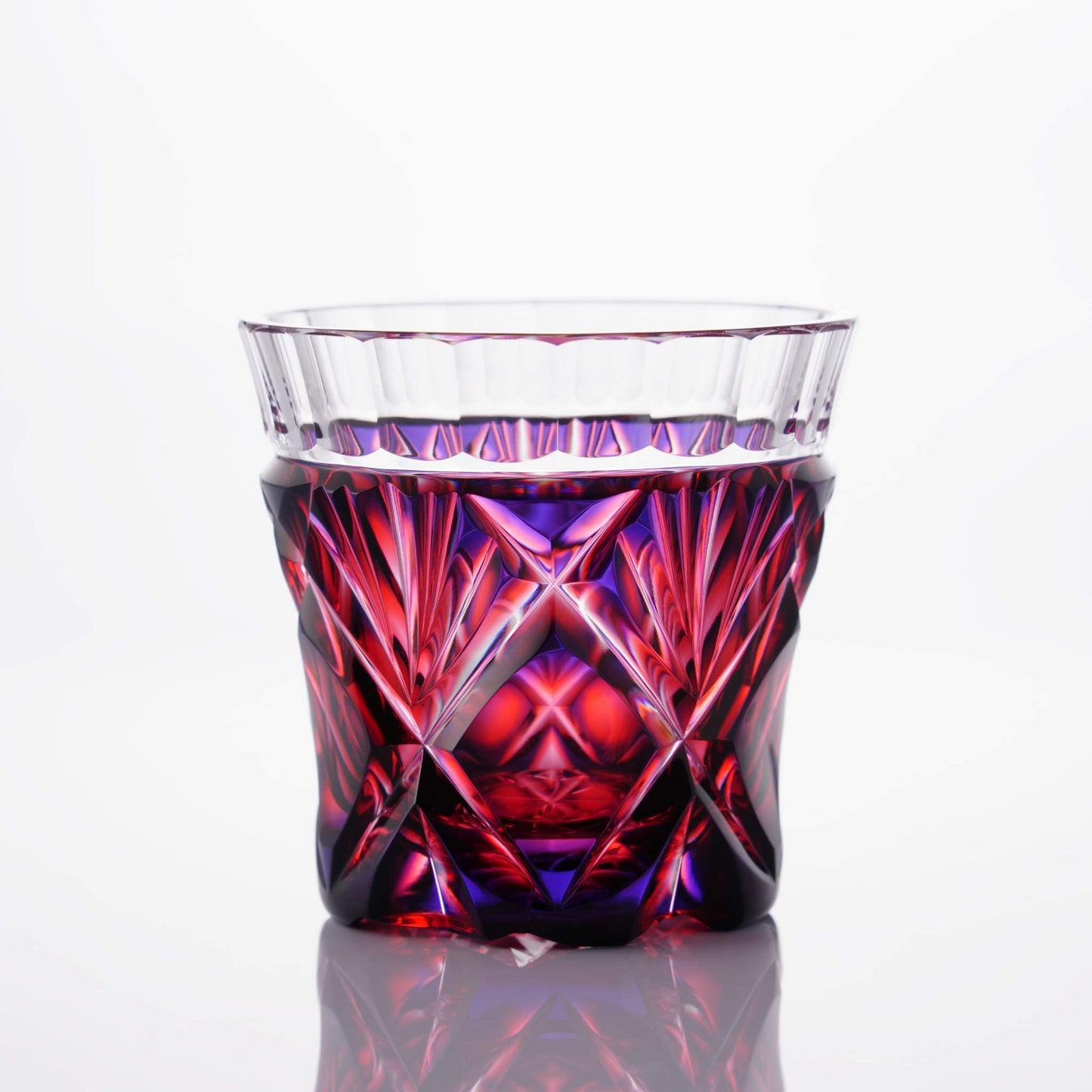 Full view of Satsuma Kiriko two-tone sake cup with a red and purple gradient and sharp, geometric designs.