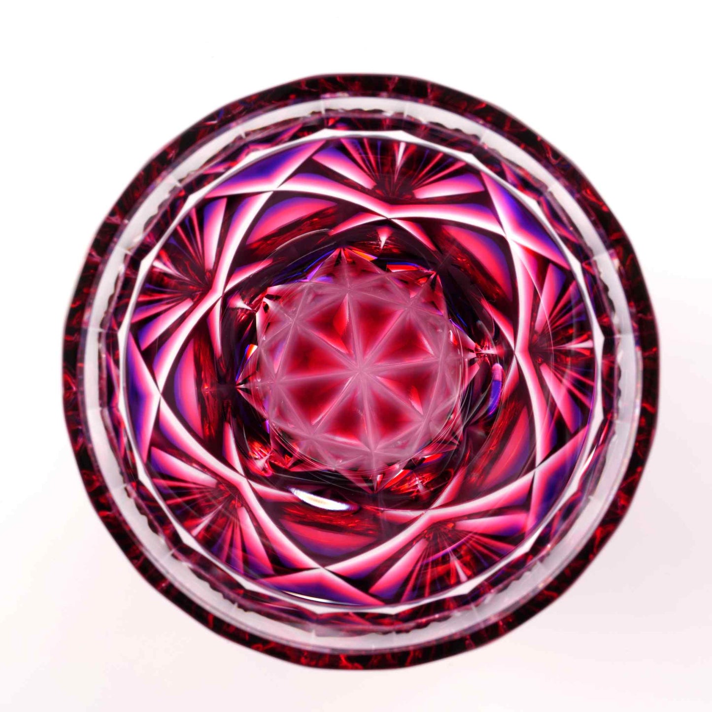 Top view of Satsuma Kiriko two-tone sake cup in vibrant red and purple hues with intricate star patterns.