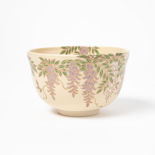 Profile view of a matcha bowl with elegant wisteria floral designs, emphasizing the delicate balance of colors and craftsmanship.