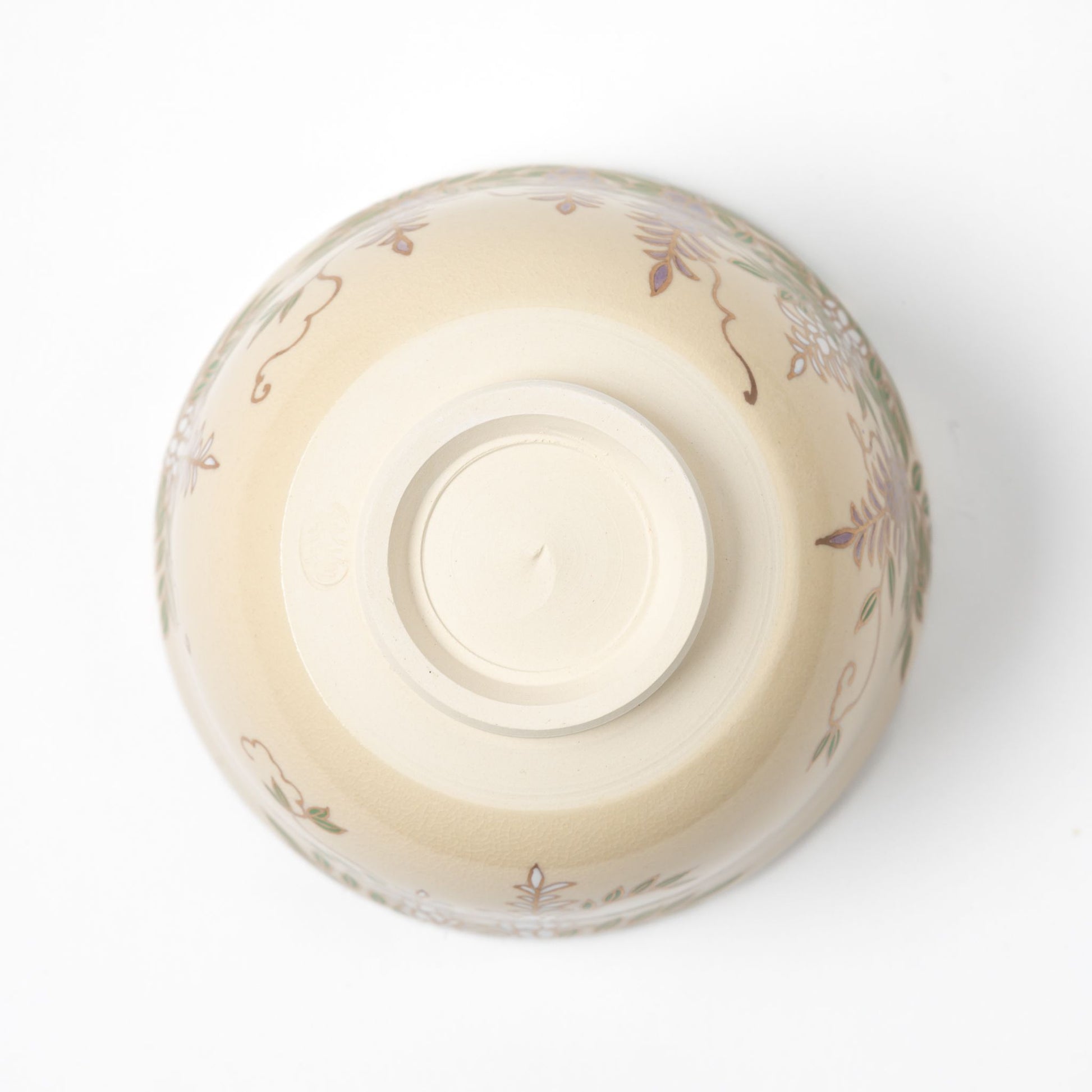 Underside view of a traditional matcha bowl showcasing a smooth, unglazed base with a light cream color.