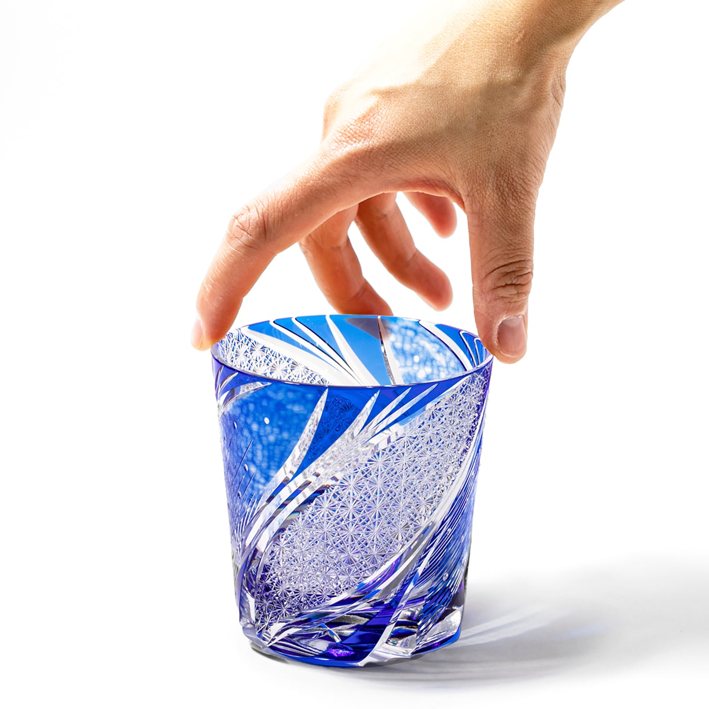 Hand holding Azure blue Edo Kiriko Meteor Whiskey Glass from Tableau